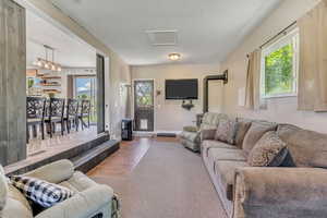 Living area with a textured ceiling and carpet