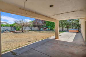Fenced backyard with a patio area and a playground