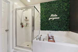 Bathroom featuring a shower stall and a garden tub