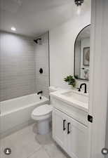 Full bath featuring tile patterned flooring, vanity, and  shower combination