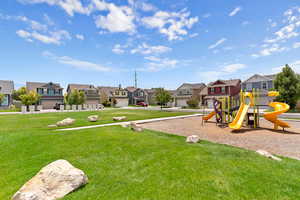 Community jungle gym featuring a residential view and a yard