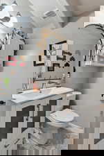 Half bathroom featuring toilet and vanity