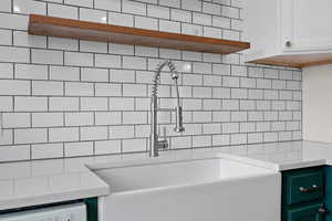 Bathroom with a sink and decorative backsplash