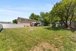 View of yard with stairway and a wooden deck