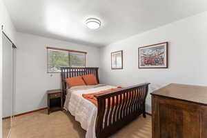 Bedroom featuring light colored carpet and baseboards