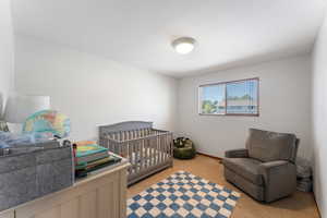 Bedroom with light colored carpet and baseboards