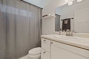 Full bath with vanity and a shower with shower curtain