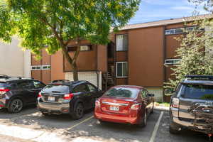 View of property featuring uncovered parking