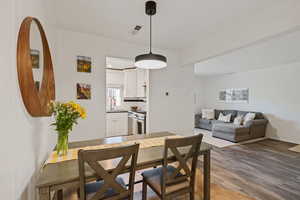 Dining room featuring dark wood-type flooring