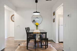 Dining space with wood finished floors and baseboards