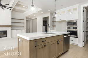 Kitchen featuring stainless steel appliances, a sink, open shelves, light wood-style floors, and recessed lighting