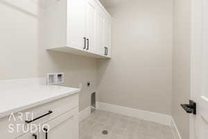 Washroom featuring cabinet space, baseboards, electric dryer hookup, and washer hookup
