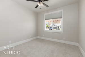 Empty room with carpet, ceiling fan, and baseboards