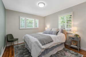 Bedroom featuring multiple windows and wood finished floors