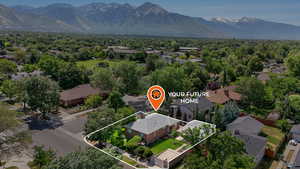 Aerial perspective with property boundaries highlighted and a mountainous background