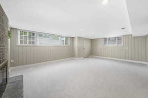 Spacious family room with new carpet floors and a gas fireplace (insert needed)  and daylight windows
