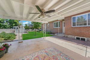 View of patio / terrace with ceiling fan and a gate