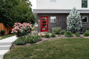 Property entrance featuring brick siding