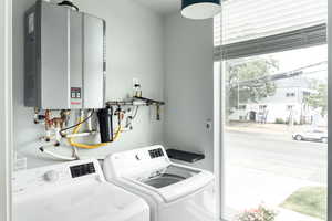 Laundry area featuring water heater and washer and dryer