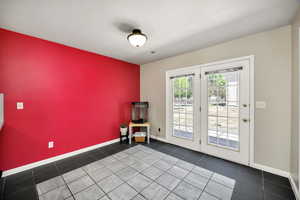 Unfurnished room with an accent wall and tile patterned floors
