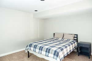 Carpeted bedroom featuring baseboards