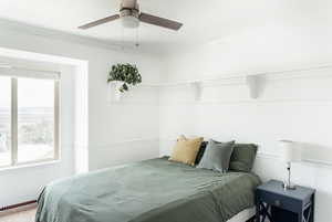 Bedroom with multiple windows, crown molding, and ceiling fan