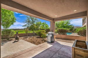 Fenced backyard featuring a patio area and grilling area