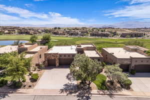 Aerial view of residential area with a water and mountain view and a golf course