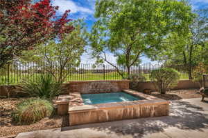 View of pool with an in-ground hot tub