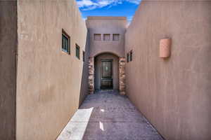 View of exterior entry with stucco siding