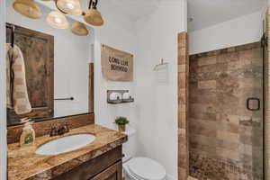 Full bathroom with tiled shower and vanity