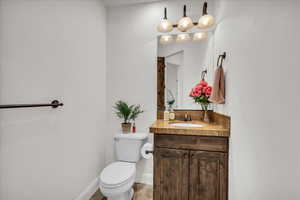 Bathroom featuring vanity and toilet