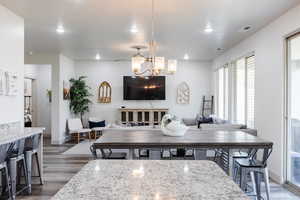 Dining area featuring dark wood-type flooring, recessed lighting, and a chandelier