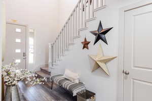Foyer with stairs and wood finished floors