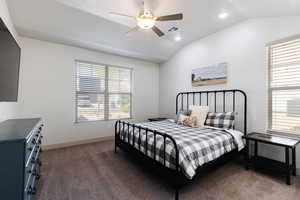 Carpeted bedroom with vaulted ceiling, recessed lighting, and ceiling fan
