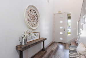 Foyer with wood finished floors and baseboards