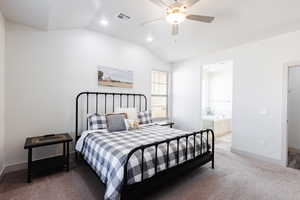 Bedroom featuring vaulted ceiling, carpet floors, recessed lighting, ensuite bathroom, and a ceiling fan