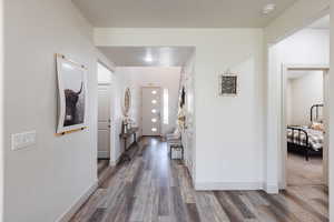 Corridor featuring wood finished floors