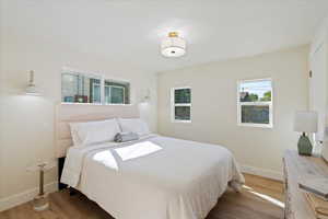 Bedroom with baseboards and wood finished floors