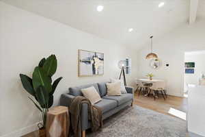 Living room with wood finished floors, recessed lighting, and healthy amount of natural light