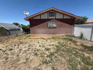View of side of property featuring brick siding and stucco siding