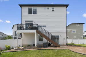 Rear view of house featuring stairway and a fenced backyard