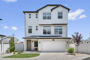 View of front of home featuring a garage and decorative driveway