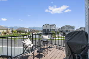 Wooden deck with a residential view, a mountain view, and grilling area