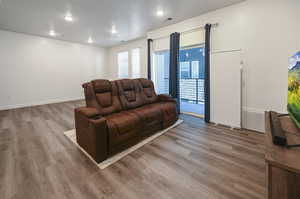 Living room with wood finished floors and recessed lighting