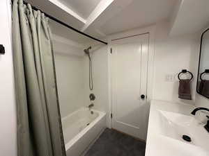 Full bathroom featuring shower / tub combo and tile patterned floors
