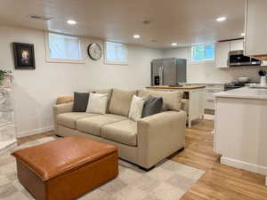 Living area with recessed lighting and light wood finished floors