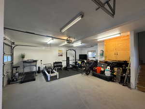 Garage featuring a garage door opener and a workshop area