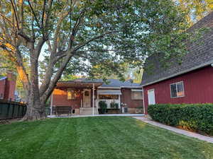 Back of house with a pergola, roof with shingles, a patio area, and brick siding