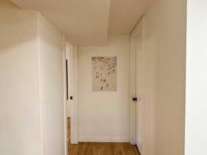 Corridor with light wood finished floors and baseboards